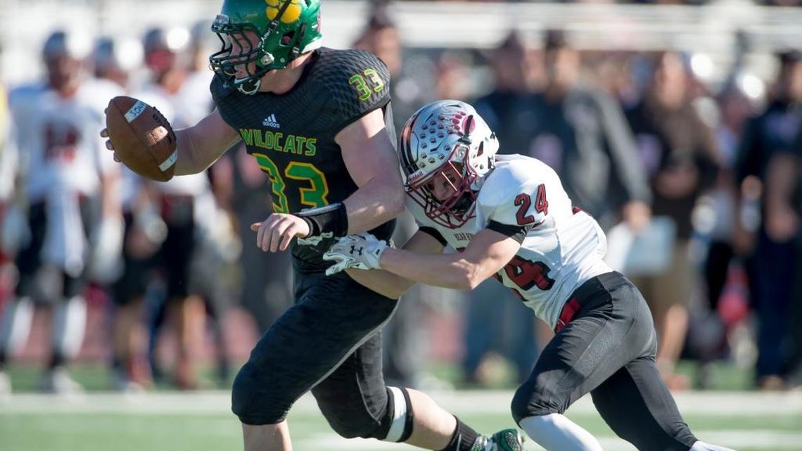 Sonora High School’s Brett McCutchen, left, runs with the ball as he is hit by Bear River’s Mason Picard during the Division V Sac-Joaquin Section football final played at Elk Grove High School, Saturday Nov. 28, 2015.