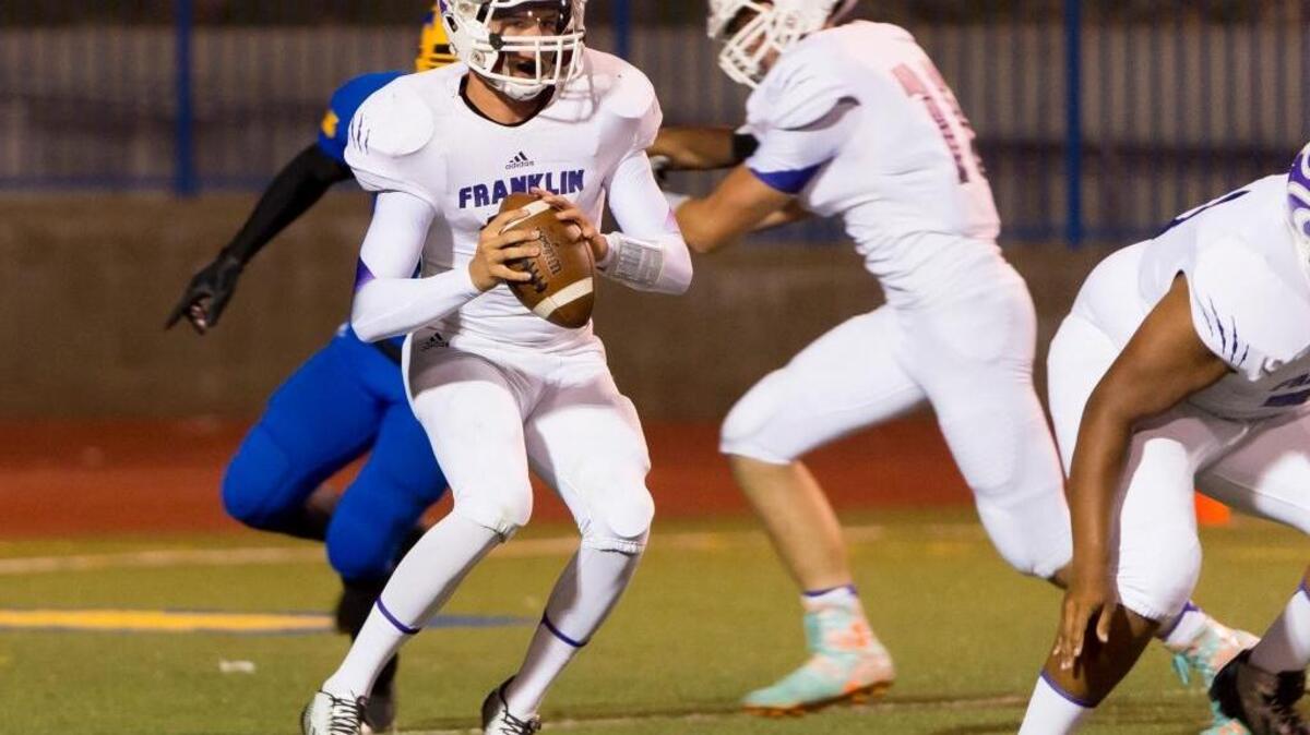 In a Sept. 26, 2014 game against Grant, Franklin High School quarterback Jacob Lopez (12), looks to pass. During a game last week against Jesuit, Lopez suffered a broken femur and dislocated ankle when he was tackled after a 30-yeard run.