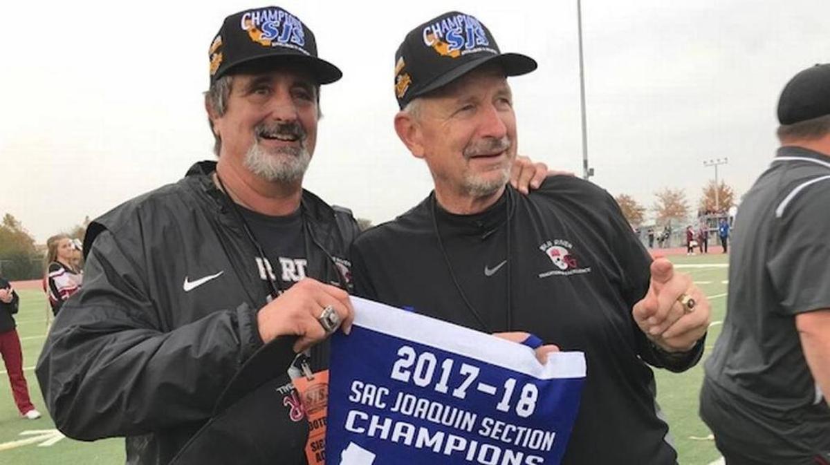 Football coaches Scott Savoie, left, and Terry Logue showcase the CIF Sac-Joaquin Section banner Bear River won in 2017.&nbsp;A 251-game winner, Logue said football offers discipline and structure for teenagers.&nbsp;