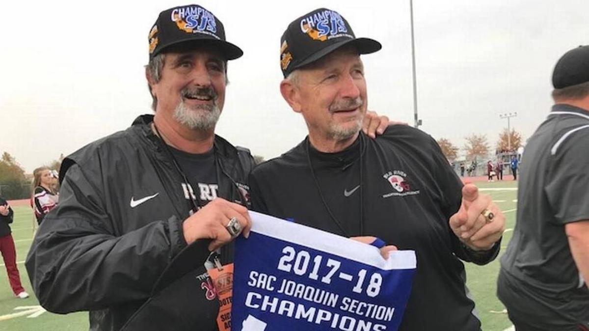 Scott Savoie, left, and Terry Logue showcase the Sac-Joaquin Section banner Bear River won this season. The longtime friends are The Bee’s Coaches of the Year.
