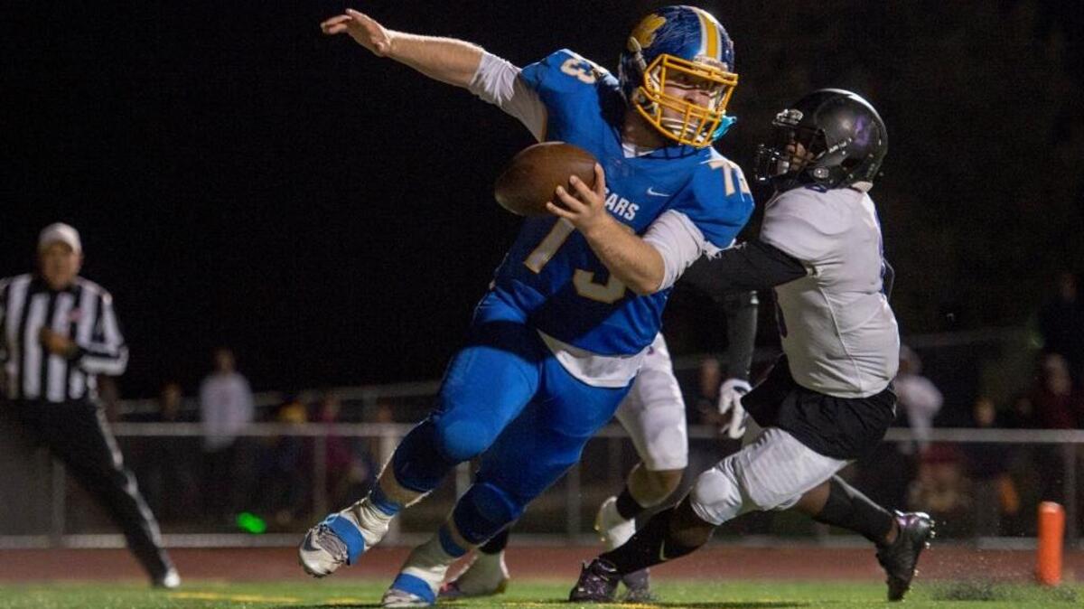 Del Campo’s Jacob Rhea tries to evade Sacramento tacklers before being brought down at the one-yard line during Friday’s Sac-Joaquin Section Division II playoff game.