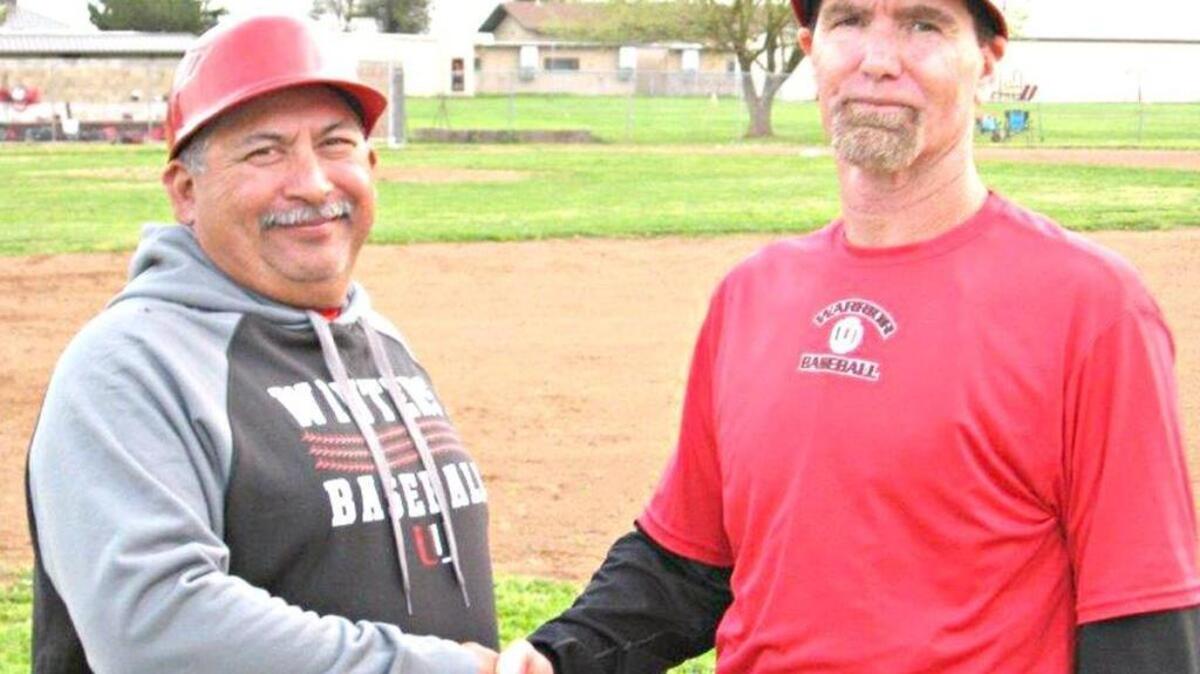 Winters High School baseball coach Jeff Ingles, right, wins his 500th career game at his alma mater on March 3, 2016, a 3-2 nonleague win over East Nicolaus. Assistant coach Jeff Saragosa, left, offers congratulations.