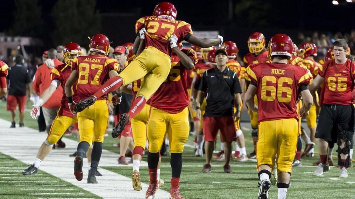 
Jesuit's, Dalvin Jamal-Milton (27), celebrates his third quart touchdown to lead 31-3 during the annual Holy Bowl between the Christian Brothers Falcons and the Jesuit Marauders at Hughes Stadium, Saturday September 12, 2015.

