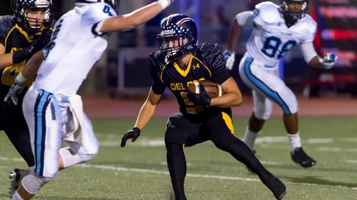 
Del Oro Golden Eagles Dalton Gee (5) runs with the ball during the first quarter against the Bellarmine Bells on Friday. 
