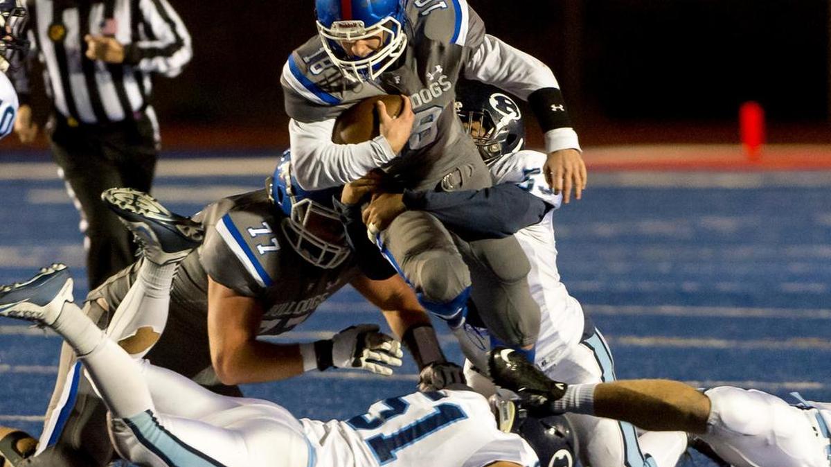 Folsom quarterback Jake Jeffrey carries the ball in the first quarter of the CIF Northern California Regional Division I-AA championship game.