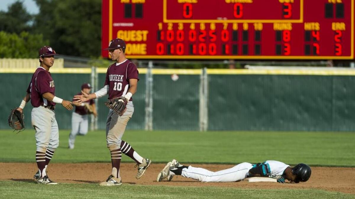 Woodcreek High’s Justin Watari, left, and Tyler Malone celebrate as Sheldon’s Burle Dixon lies on second after he was tagged for the last out of the Timberwolves’ 8-3 win at Sacramento City College on Thursday.