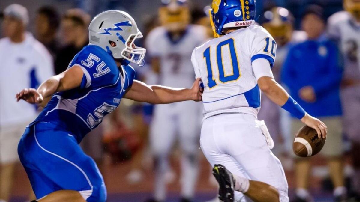 Rocklin’s Jonah Wehrli (54) applies pressure on Del Campo’s Ben Purell (10) during the third quarter in Rocklin on Sept. 4.