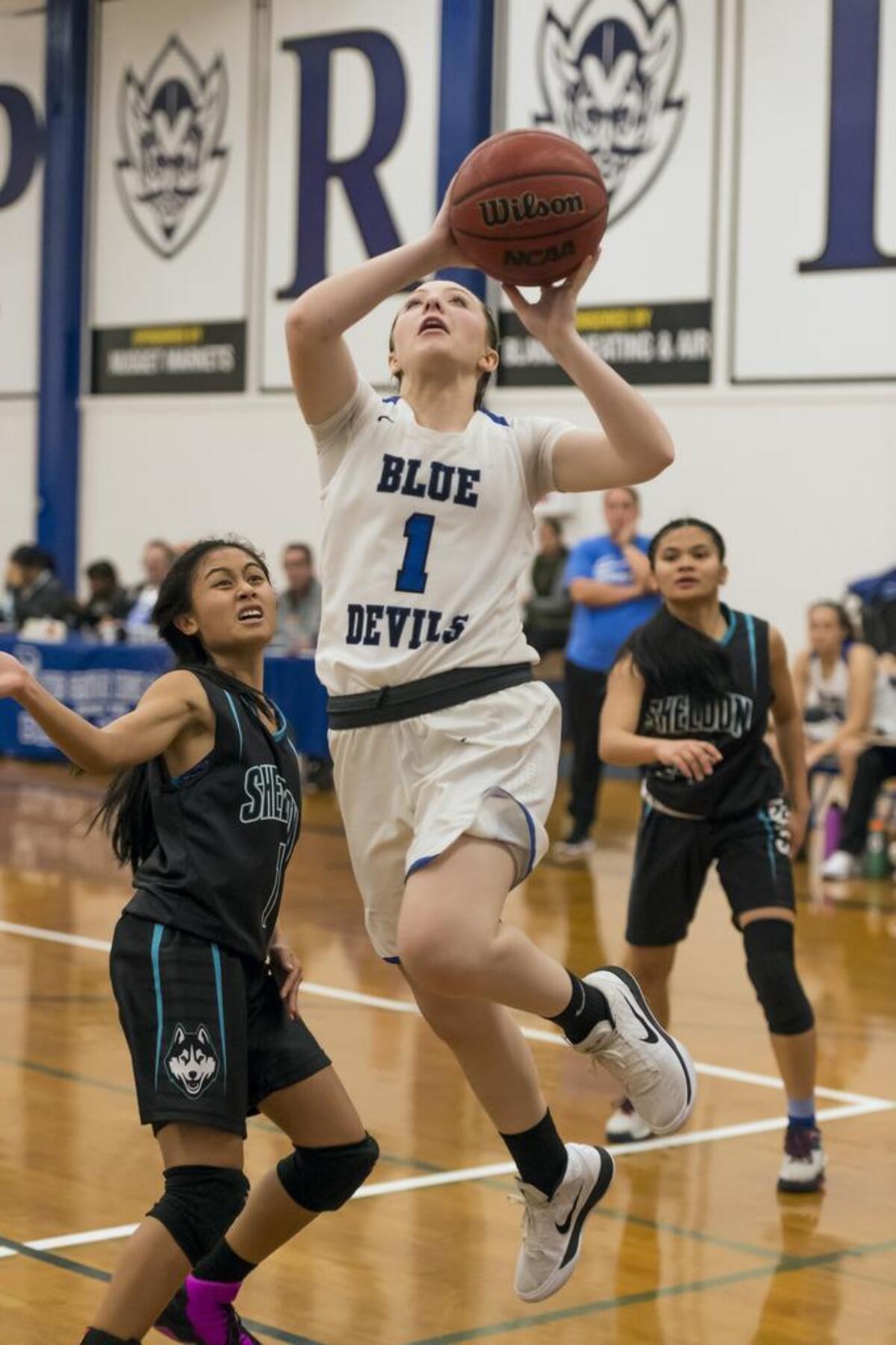Davis High School Lady Blue Devils Kelsey Forrester (1) shots the ball as the Davis High School girls basketball team host the Sheldon Huskies on Wednesday.