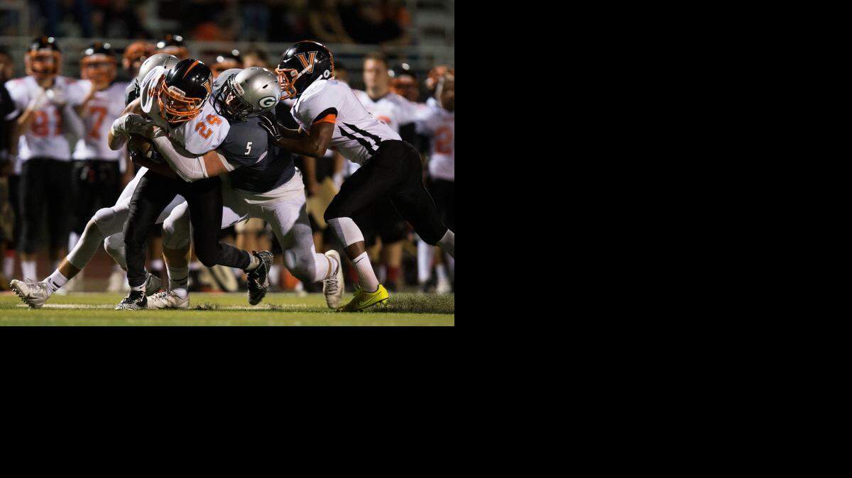 
Vacaville fullback Kane Cunningham (24) is brought down by Granite Bay player Cameron Smith (5) at the first quarter during the Vacaville and Granite Bay high school football game on Sept. 19, 2014, in Granite Bay.
