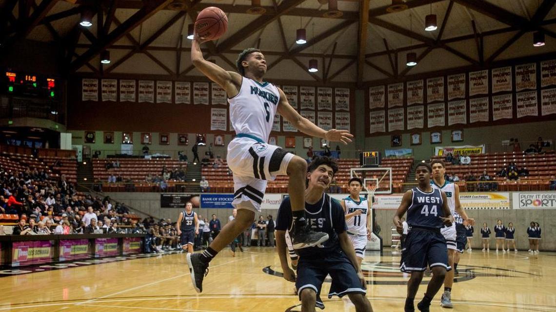 Sheldon guard Dom Johnson (5) rises to the rim over West guard Isaac Paz during their Sac-Joaquin Section semifinal. The Huskies are headed to their sixth final this decade.