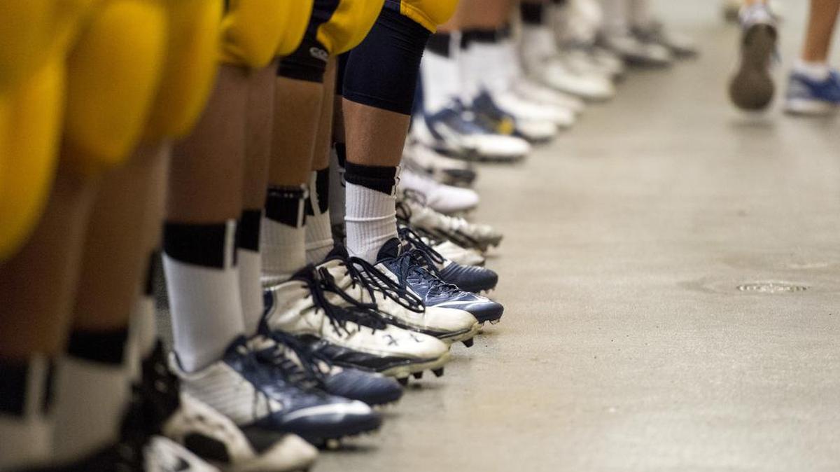 
Members of the Oak Ridge Trojan football team listen to Oak Ridge Trojan head coach Eric Cavaliere inside the locker room before the game as Oak Ridge high School hosts Burbank High School Friday September 12, 2014. Michael Pittman of this year’s team won the first prep of the week poll. 
