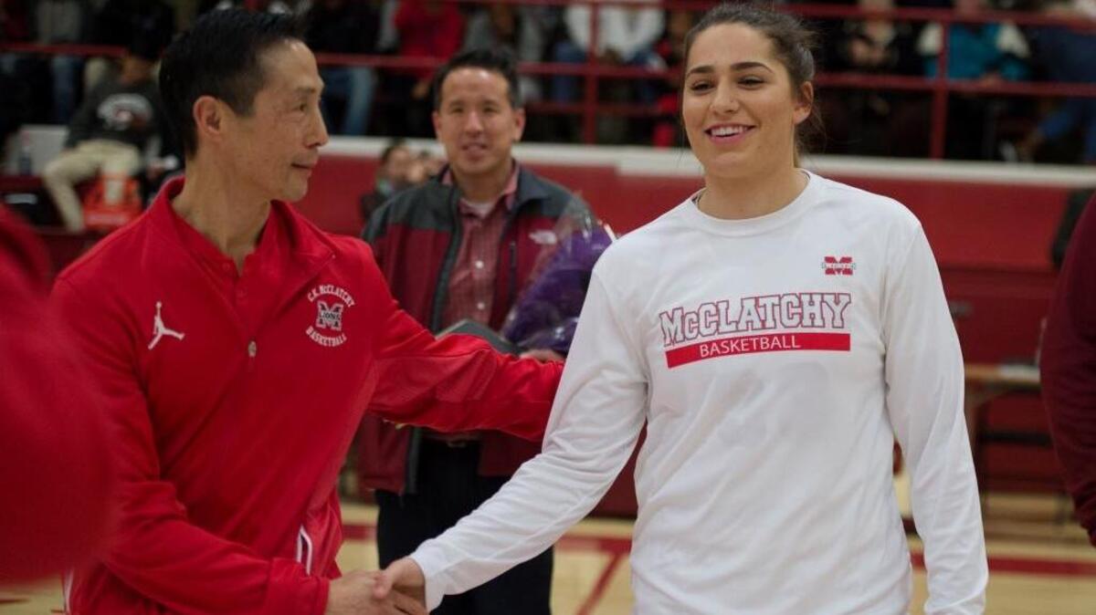 McClatchy girls basketball coach Jeff Ota, left, congratulates Jordan Cruz during a ceremony for her nomination to the McDonald’s All-American team on Wednesday, Jan. 24, 2017, at McClatchy High School in Sacramento, Calif.