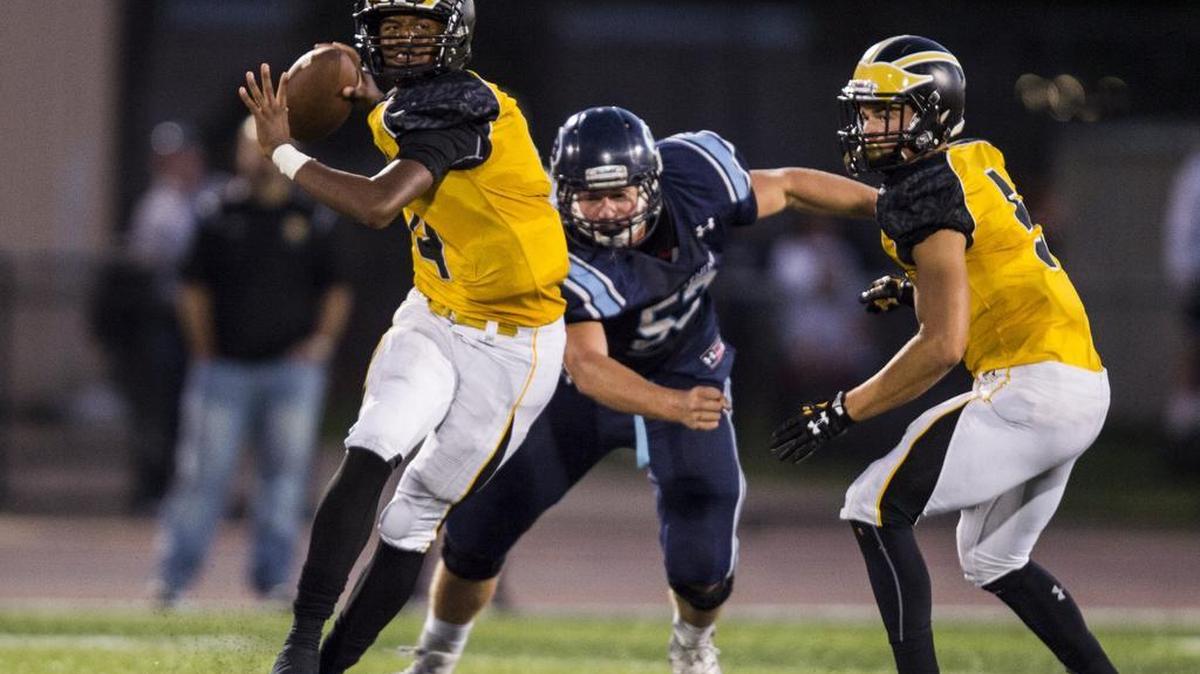 Del Oro Golden Eagles Stone Smartt (4) looks for an open man during the second quarter at a game between the Del Oro Golden Eagles and San Jose's Bellarmine College Prepatory School on Friday, Sept. 9, 2016, at San Jose City College in San Jose.
