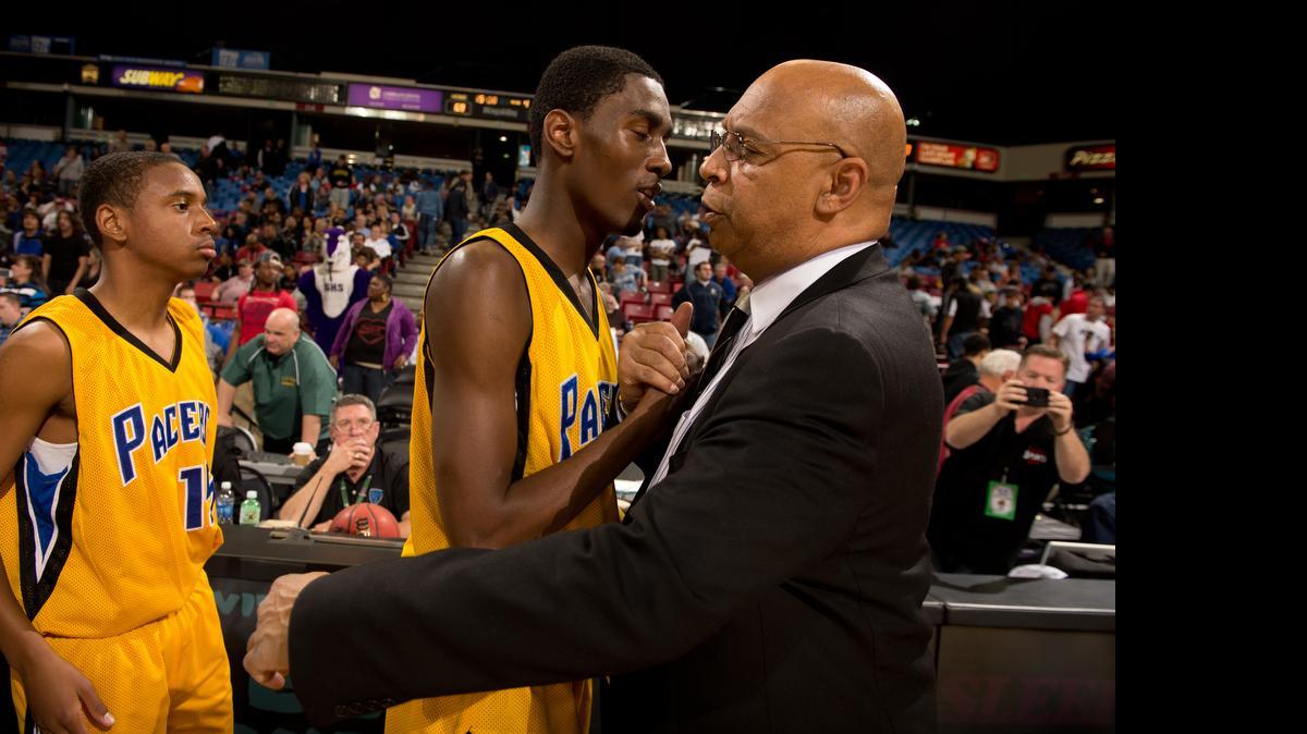
Sacramento High coach Derek Swafford embraces Grant's De'Sean Parsons following the Division II semifinal between Sacramento and Grant High School on February 27, 2013 at the Sleep train Arena in Sacramento.
