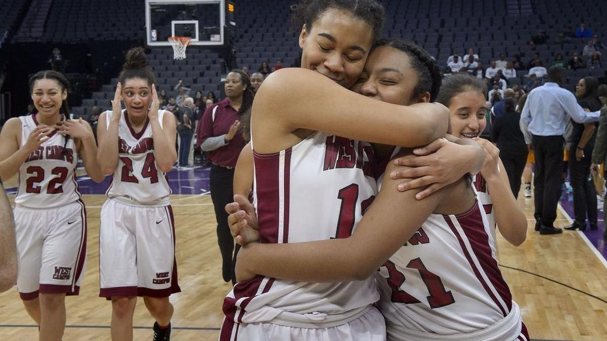 West Campus Warriors Alexandra Dent, center, and Jasalyn Brown congratulate each other Saturday following the Division IV girls state basketball championship with the Los Osos Grizzlies at Golden 1 Center. The Warriors won the title 63-55.