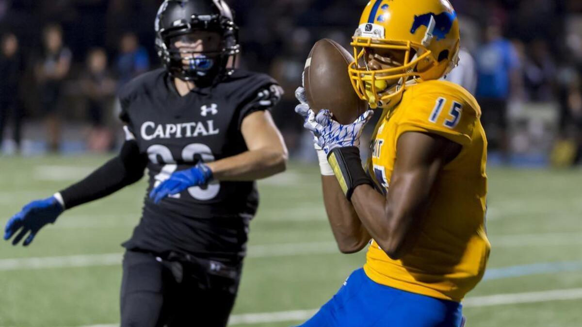 Grant’s Parris Warren (15) catches the ball for a touchdown making the score 19-0 after the point after attempt was good during the third quarter on Friday against Capital Christian.