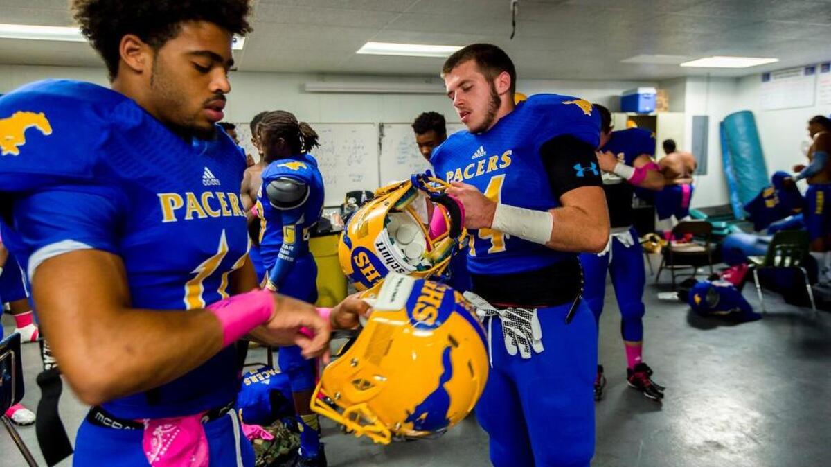 
Grant’s Elijah Orr (11) and Josh Wright (14) get ready in the locker room before the game as against Elk Grove on Oct. 2. 
