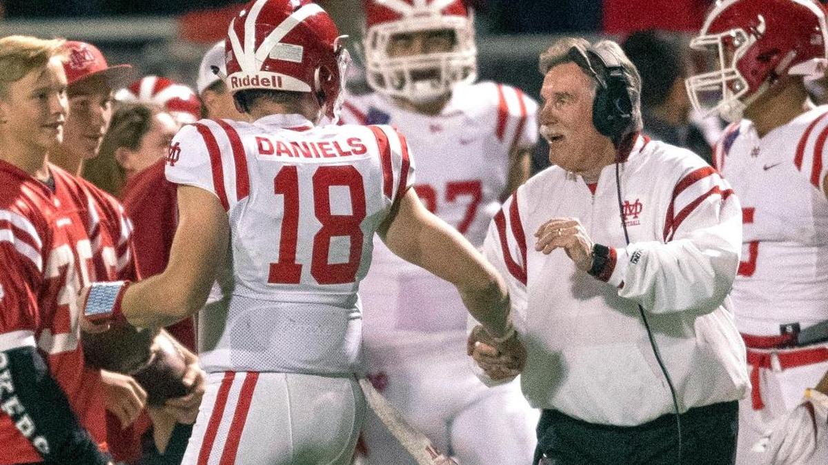 Mater Dei coach Bruce Rollinson congratulates quarterback JT Daniels after Daniels sprinted for a touchdown against Mission Viejo in the playoffs on Nov. 24.