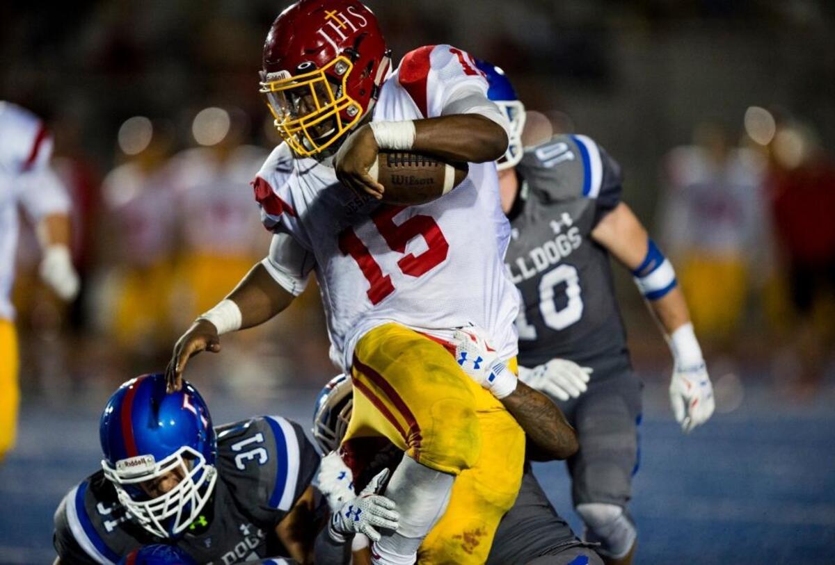 Running back Lorenzo Burkes (15) and No. 2 Jesuit open the season against No. 3 Granite Bay and No. 1 Folsom.