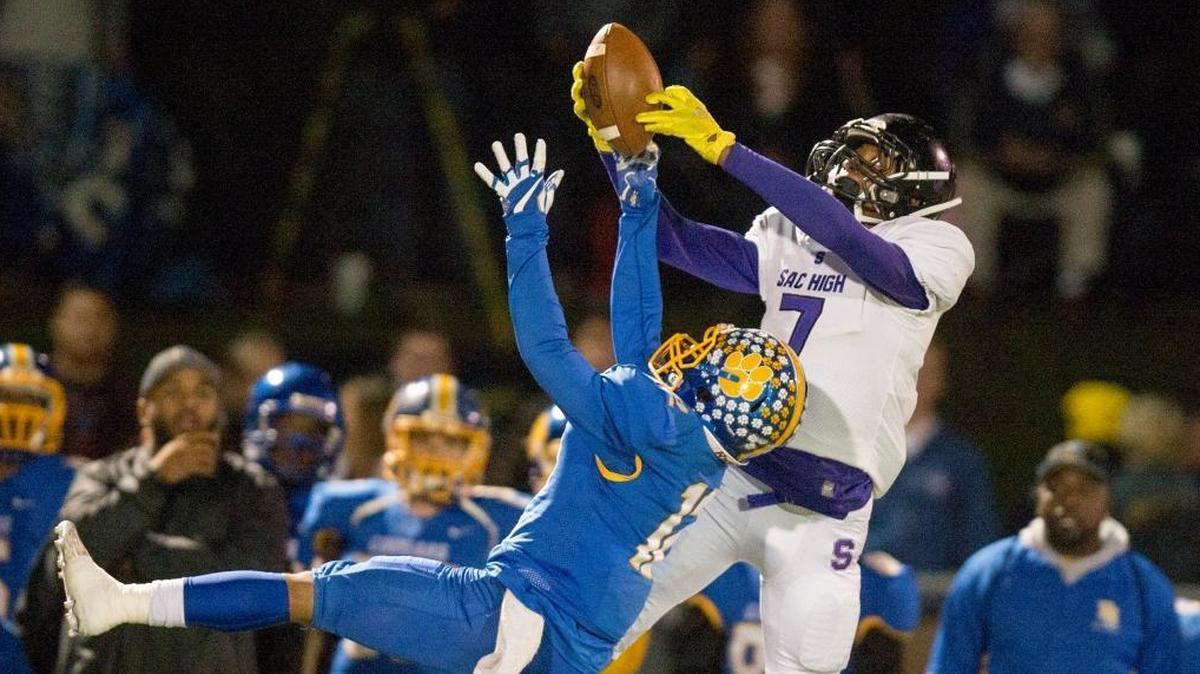 Sacramento’s Juwan Tanner (7) pulls in a catch over a Del Campo defender for a first down in a Sac-Joaquin Section second-round playoff game on Nov. 16. The senior wide receiver was named All-Metro First Team.