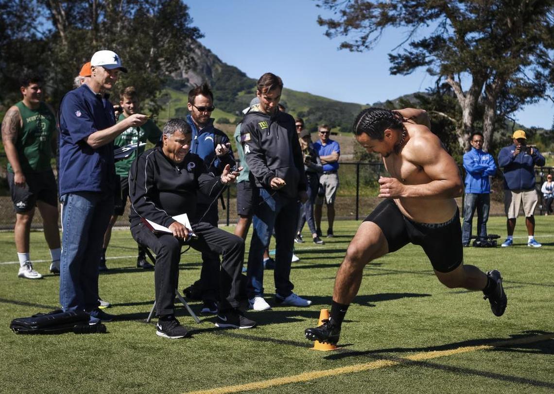 Josh Letuligasenoa, right, a two-time all-Big Sky honoree as a defensive end at Cal Poly, took several repetitions as a linebacker during position drills on Pro Day.