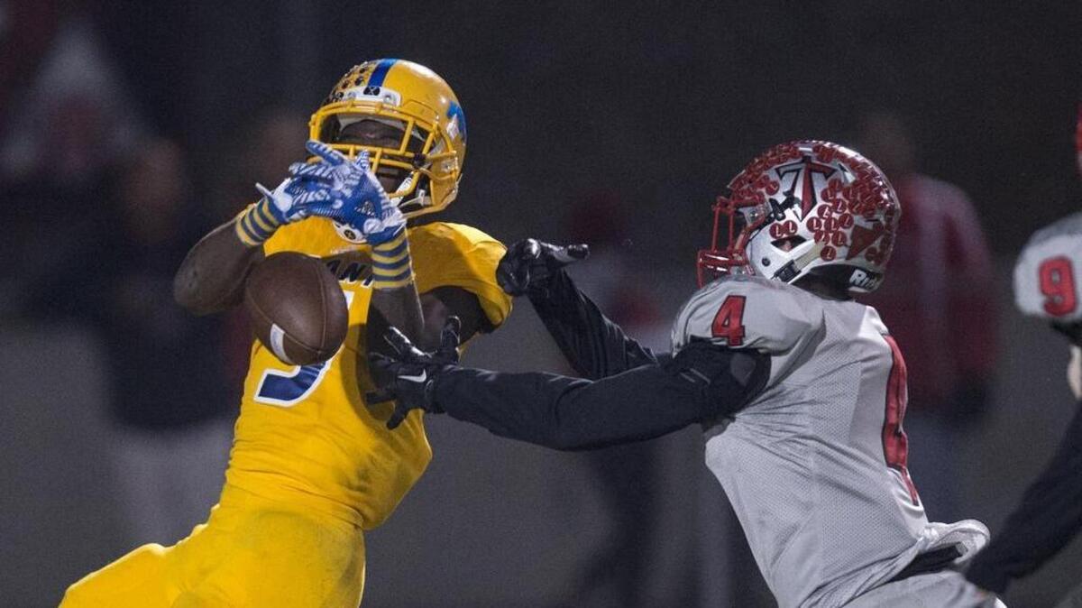 Grant Pacers Lawrence Hardy (5) drops a pass in the first quarter as he is defended by Titan's Garrett Chapman in the Sac-Joaquin Section D-ll playoff game between the Grant Pacers and Antelope Titans at Antelope High School on Friday, November 18, 2016.