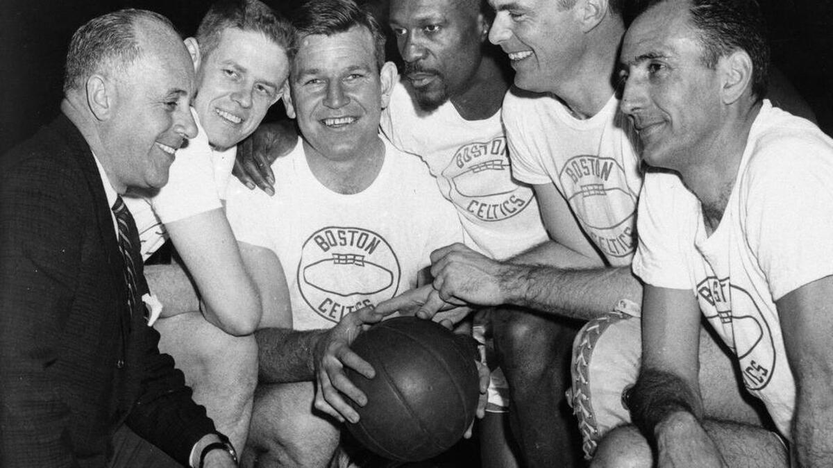 Jim Loscutoff, third from left, huddles with Boston Celtics coach Red Auerbach (left), before an NBA basketball game on March 28, 1963. From left, coach Auerbach, Frank Ramsey, Loscutoff, Bill Russell, Tom Heinsohn and Bob Cousy.