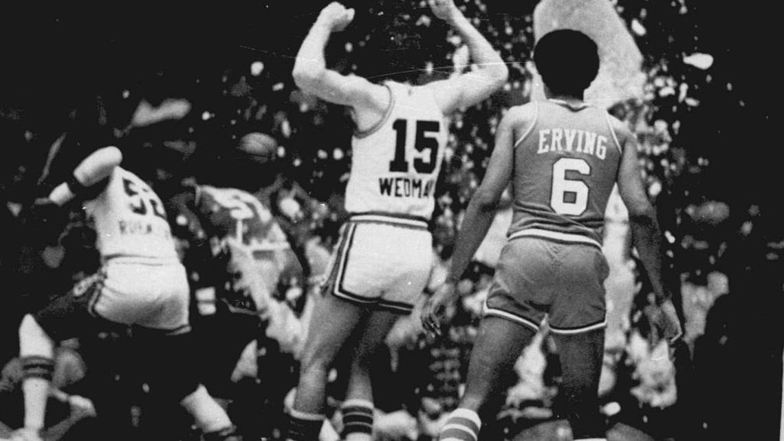 
Kansas City Kings’ Scott Wedman and Philadelphia 76ers’ Julius Erving watch as the Kings’ Bill Robinzine, left, and 76ers’ Darryl Dawkins run for cover after Dawkins shattered the glass backboard during a basketball game in November 1979 in Kansas City, Mo. Darryl Dawkins, whose backboard-shattering dunks earned him the moniker “Chocolate Thunder” and helped pave the way for breakaway rims, died Thursday. He was 58. 
