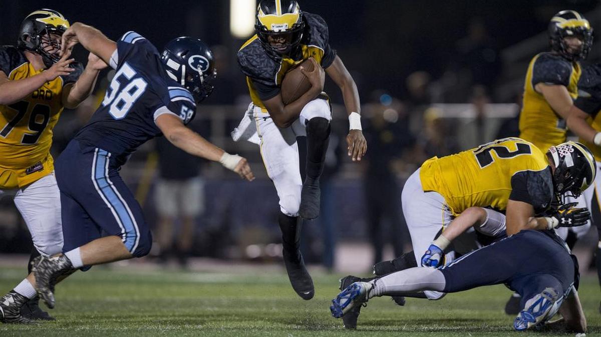 Del Oro Golden Eagles Stone Smartt (4) runs a quarterback sneak during the fourth quarter at a game between the Del Oro Golden Eagles and San Jose's Bellarmine College Prepatory School on Friday, Sept. 9, 2016, at San Jose City College in San Jose.