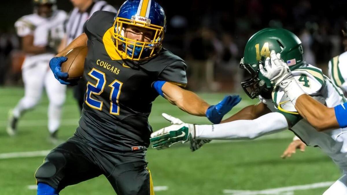 Del Campo running back Greg Cabral (21) attempts to elude a Monterey Trail defender during a game Friday, Sept. 2, 2016, at Del Campo High School.