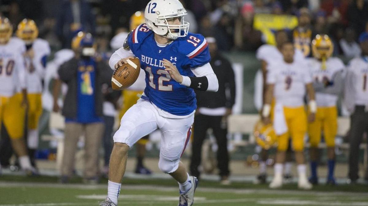 
Former Folsom quarterback Jake Browning (12) rolls out to pass during the game between the Folsom High School Bulldogs and the Grant High School Pacers at Hornet Stadium in Sacramento on Friday, December 12, 2014. This was the CIF Northern California Regional Division I football championship game.

