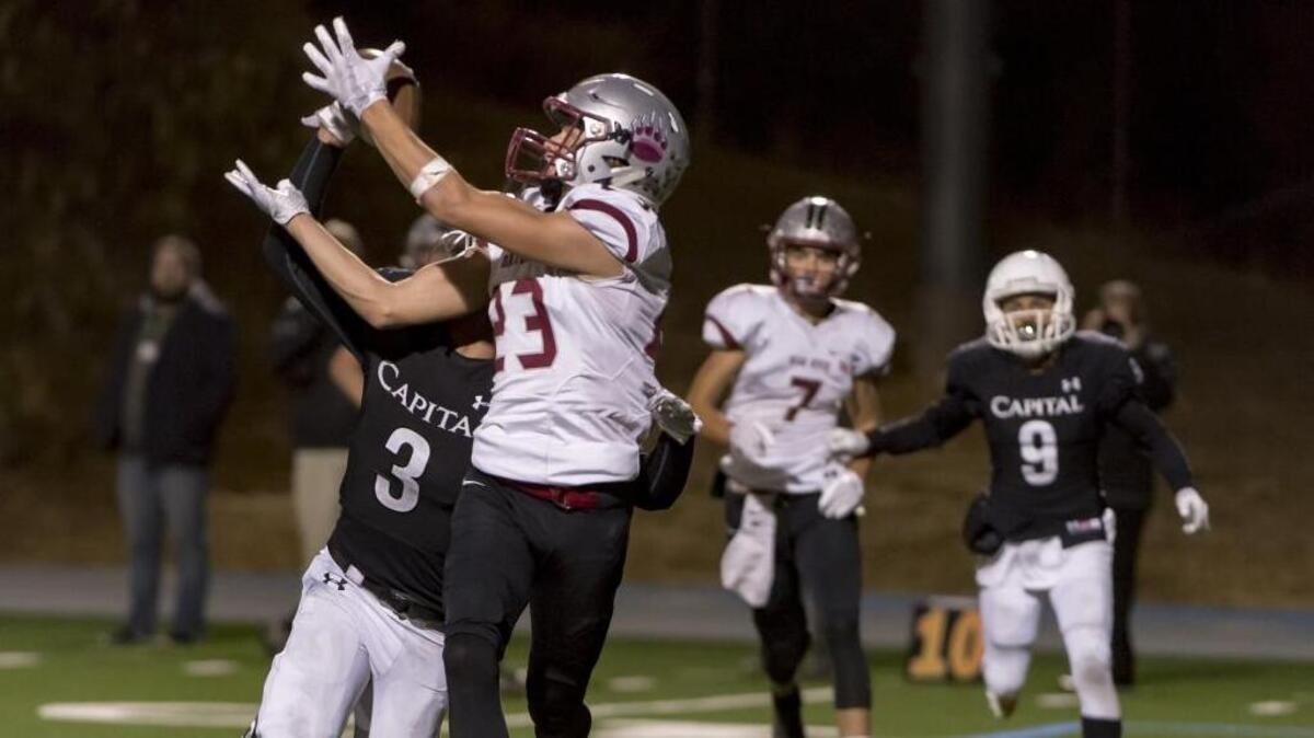 Bear River’s Calder Kunde (23) catches the ball as Capital Christian’s Maurice Gaines (3) defends during the third quarter during Thursday’s first-round Sac-Joaquin Section playoff game.