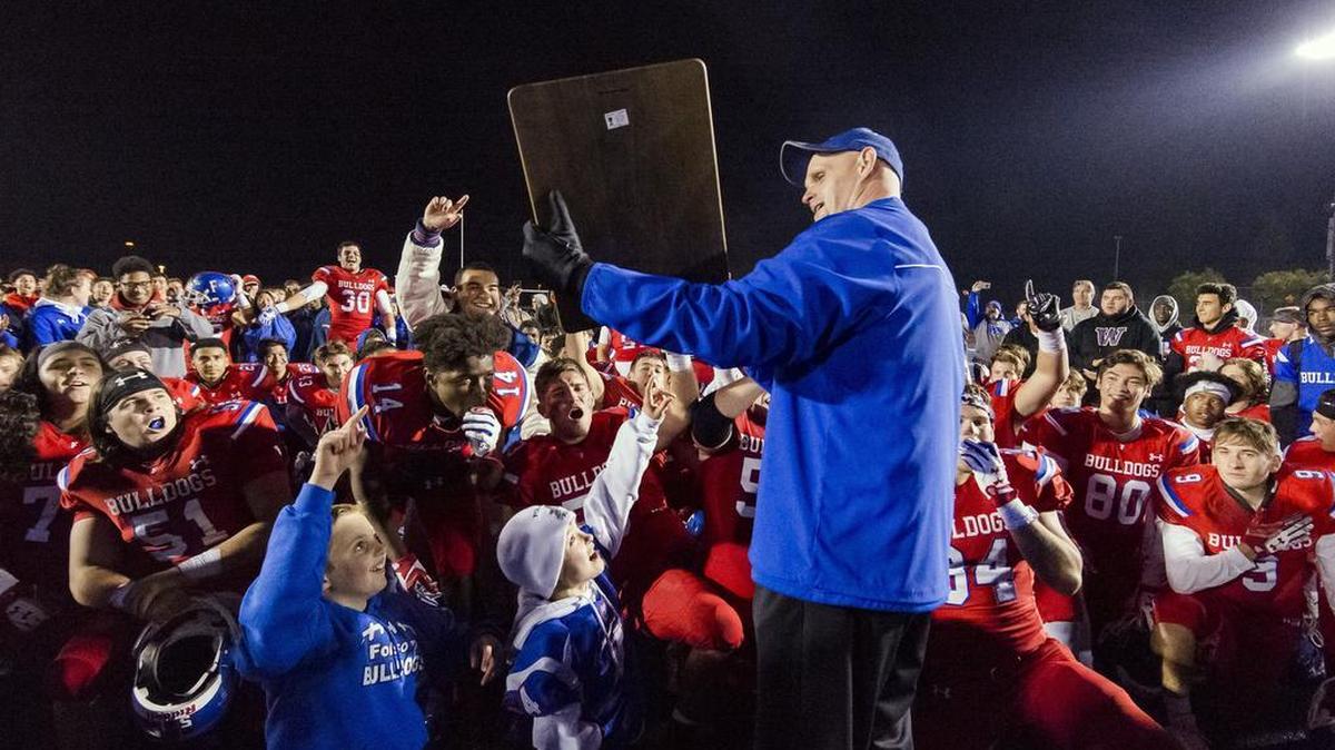 Folsom Bulldogs head coach Kris Richardson, and his team celebrate their 54-35 win over the Central High School Grizzlies in the CIF NorCal Division I-AA title game, Friday Dec 8, 2017. The winner of this game will face the CIF SoCal winner in the State Championship game at Sacramento State, Friday Dec 15th.