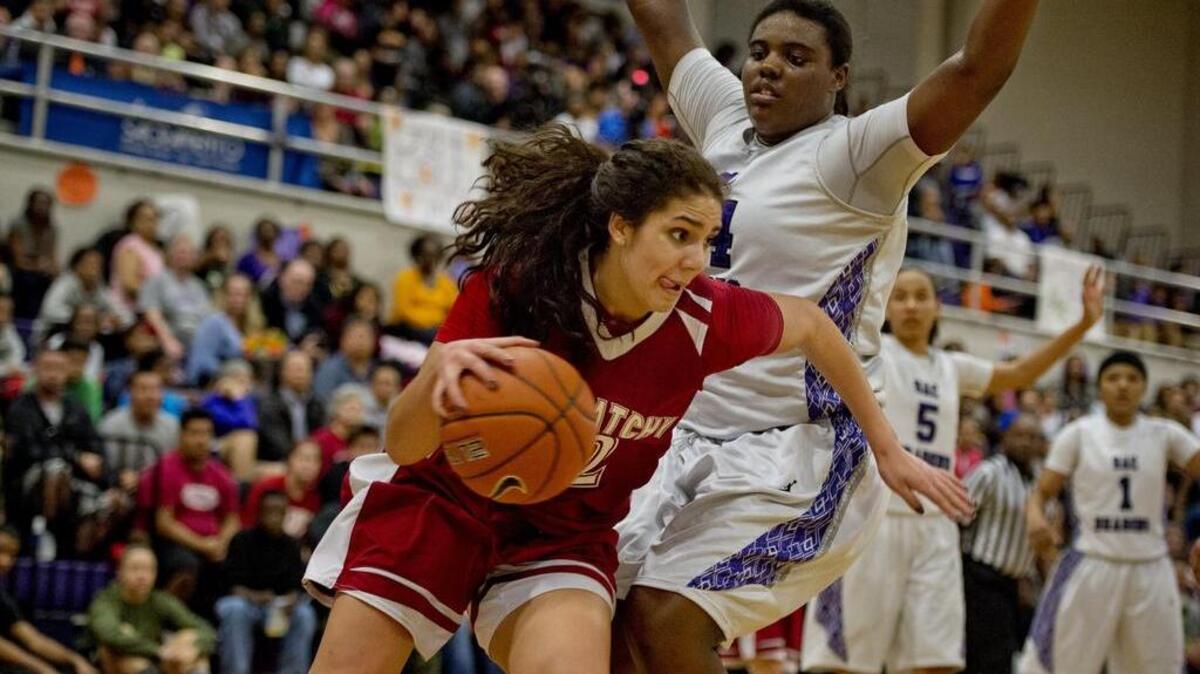 
McClatchy Lions Gigi Garcia (32) drives past Sacramento Dragons Ayanna Edwards (34) on the baseline in the first half of a basketball game on February 18, 2014 at Sacramento High School in Sacramento, Calif.
