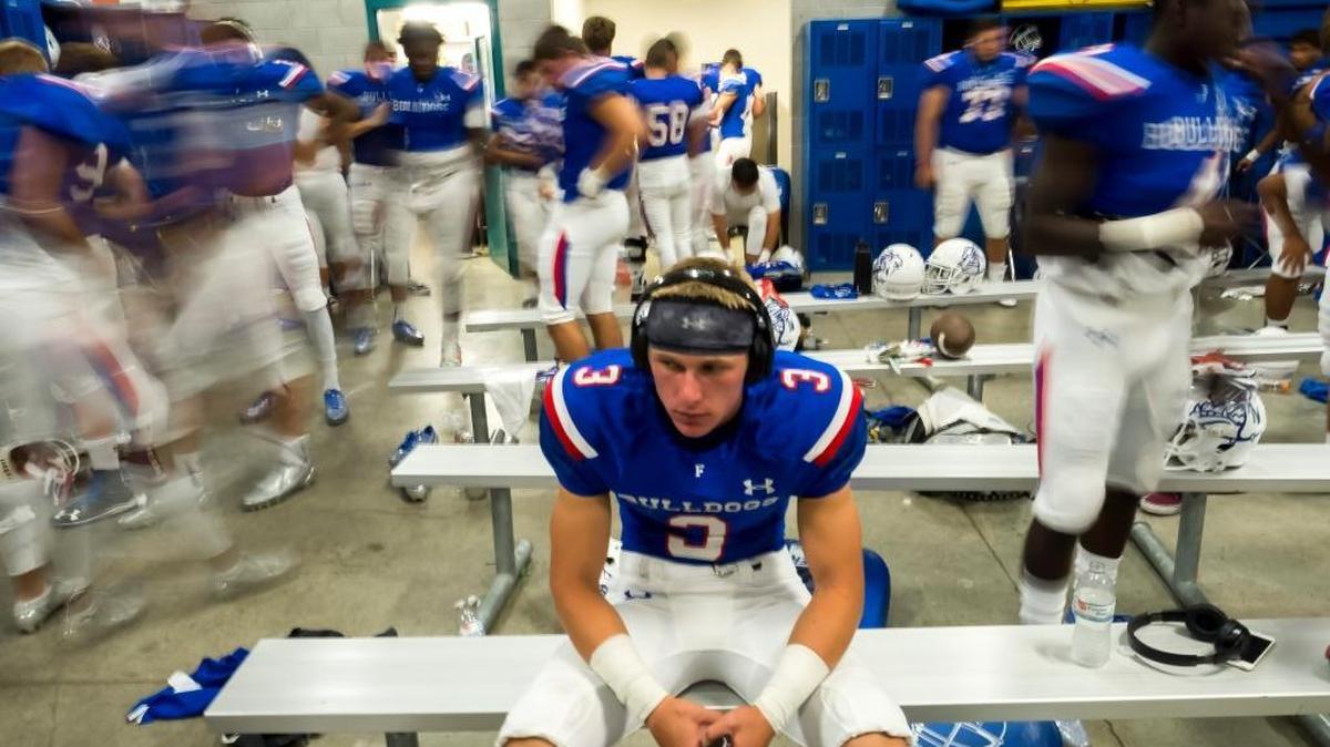 CJ Hutton and the Folsom High football team prepare for a game against Jesuit on Friday. The Bulldogs, The Bee’s top-ranked team, rolled to victory over the Marauders.