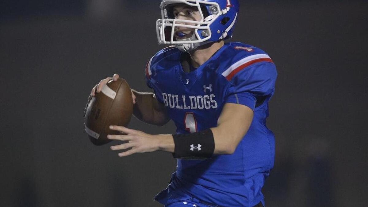 Bulldogs quarterback Joe Curry (1) scrambles during the Sac-Joaquin Section Division I semifinal game between the Folsom Bulldogs and the Elk Grove Thundering Herd at Folsom High School in Folsom on Friday, November 25, 2016.