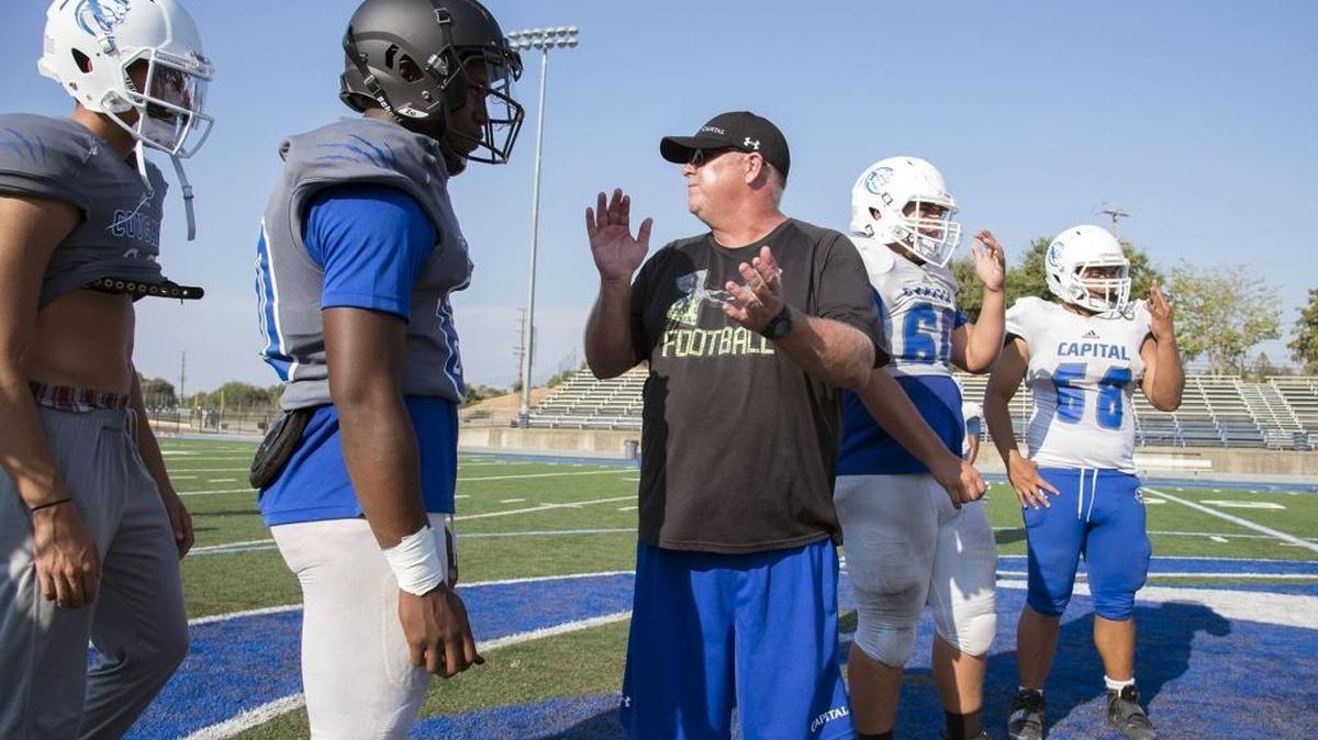 Capital Christian coach Casey Taylor works with his players at practice on Wednesday in Sacramento. Capital Christian made a bold move in its attempt to become a real football player by hiring the longtime Del Oro coach.