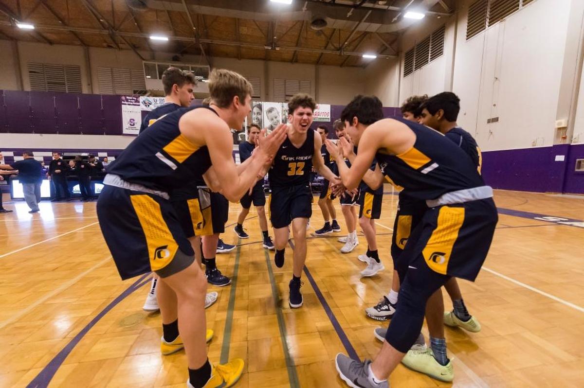 Cade Hoppe, center, led Oak Ridge to an upset victory over host Sacramento on Wednesday in the Sac-Joaquin Section Division I boys basketball playoffs.