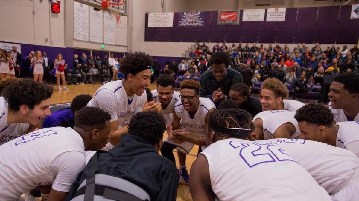 Sacramento High guard Christian Terrell (23) rallies the Dragons before their CIF NorCal basketball playoff game against Folsom on March 11, 2016.