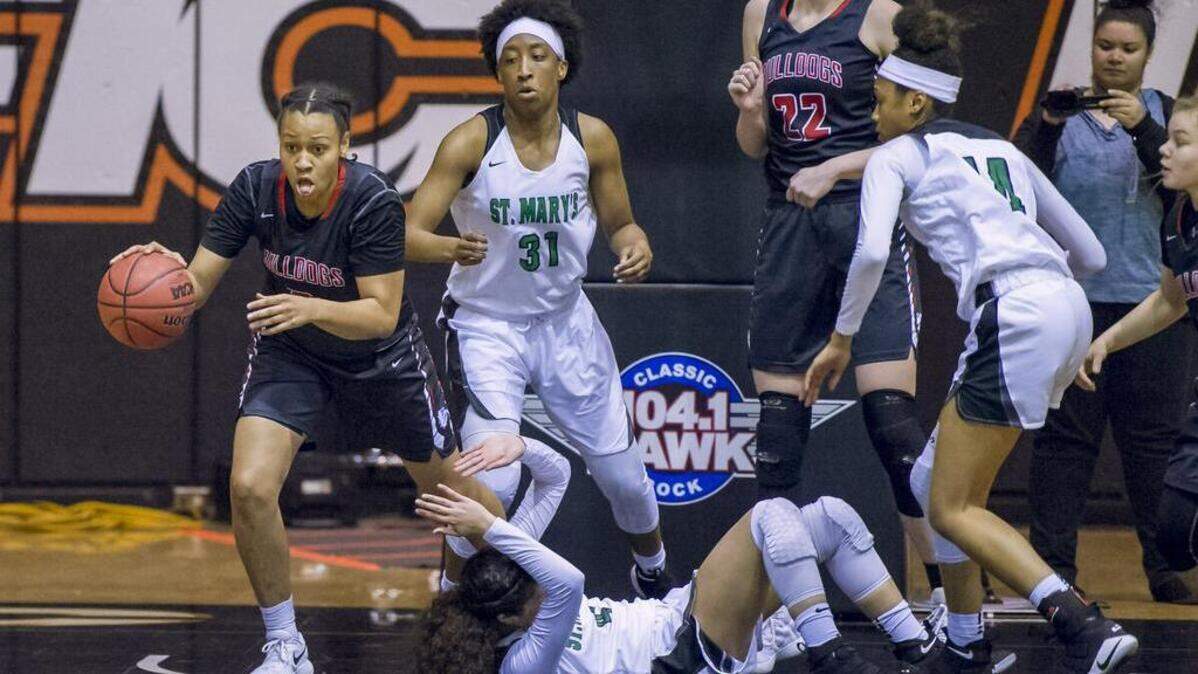 Folsom’s McKenzie Forbes, left, grabs the rebound during the first quarter of the Sac-Joaquin Section Division I girls basketball championship Saturday at Spanos Center in Stockton.