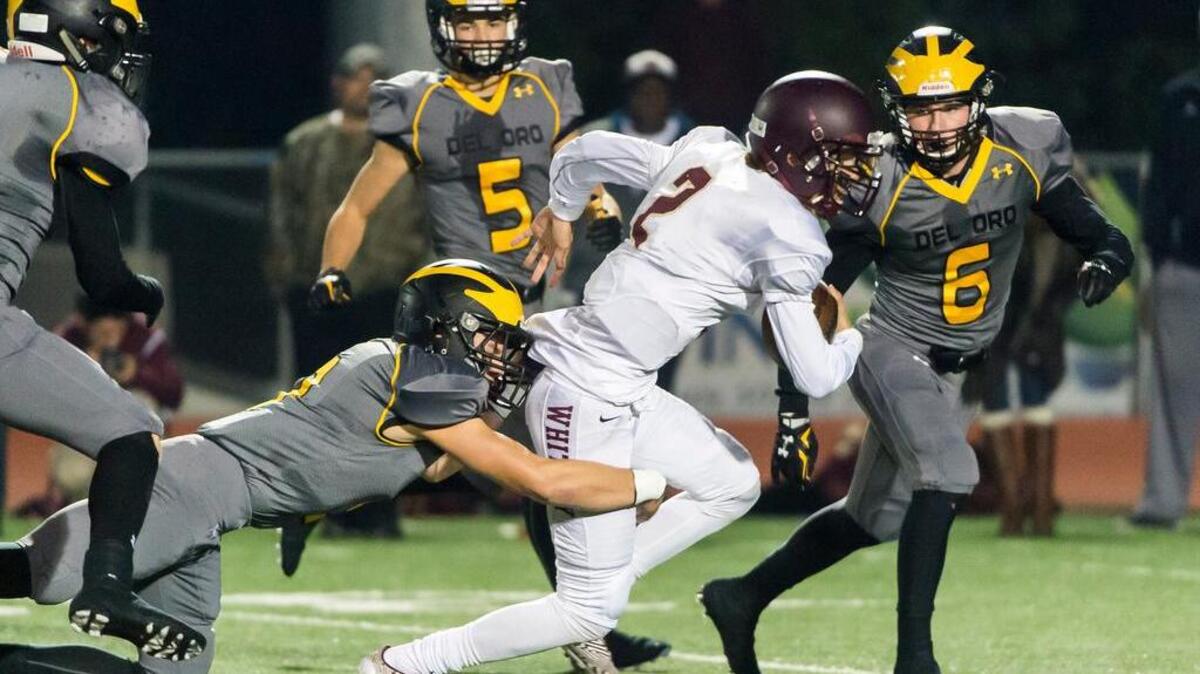 Whitney quarterback Hunter Rodrigues runs in the first quarter on Friday night. Despite Rodrigues’ 384 rushing and passing yards, Del Oro prevailed over the Wildcats.