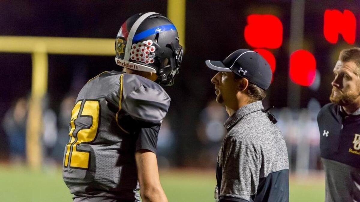 Del Oro coach Jeff Walters talks to quarterback Josh Gazzaniga (12) during the fourth quarter against Granite Bay on Sept. 22.