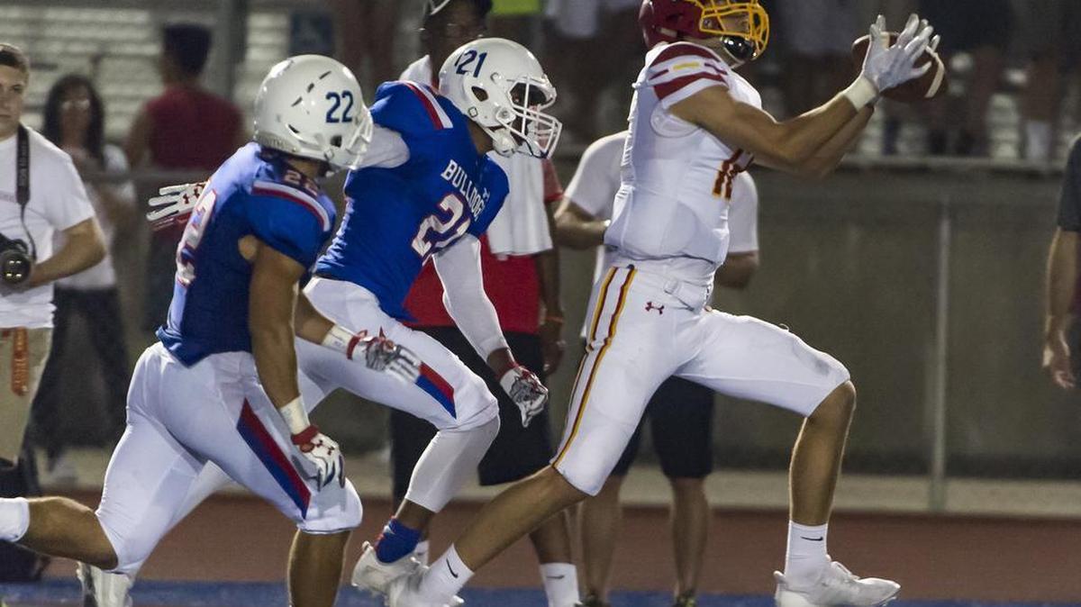 Jesuit Marauders Evan Panson (12) catches the ball for a large gain but fumbles the ball and Folsom recovered during the second quarter.
