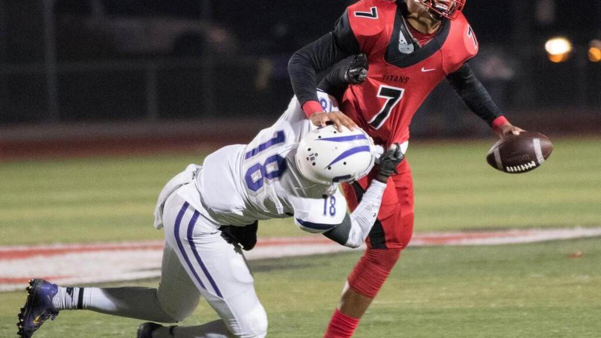 Antelope’s Montel Aaron, grabbed by Sacramento’s Anthony Johnson, threw for 2,474 yards and ran for 226 last season.