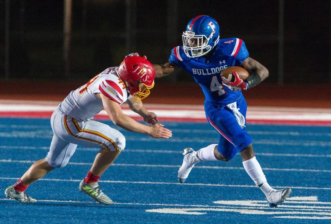 Folsom sophomore Daniyel Ngata stiff-arms Jesuit’s Maxwell Sackett during a playoff game Nov. 24. Ngata leads the Bulldogs in rushing. Folsom seeks its third CIF State title since 2010 when it faces Helix of La Mesa for the Division I-AA championship at Sacramento State on Friday.