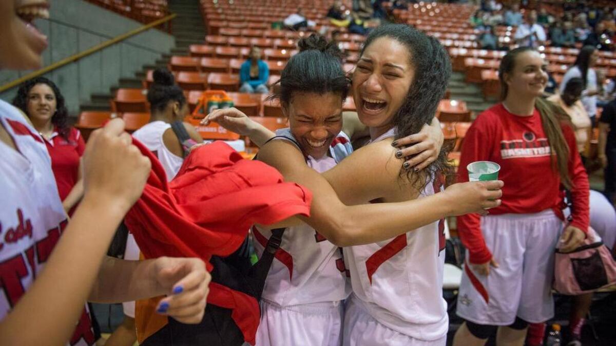 Antelope guards Aliyah Hardy, left, and Nadia Johnson celebrate after the No. 1-seeded Titans’ 68-60 win over No. 4 Sacramento on Tuesday in the Division II semifinals.