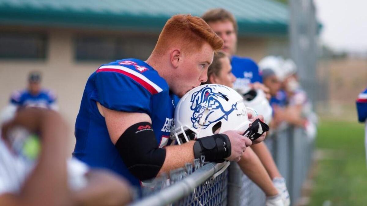 Noah Lunday, kissing his Folsom High helmet, is a member of a strong Bulldogs offensive line that helped quarterback Kaiden Bennett account for 448 total yards in a win over Jesuit this past Friday.