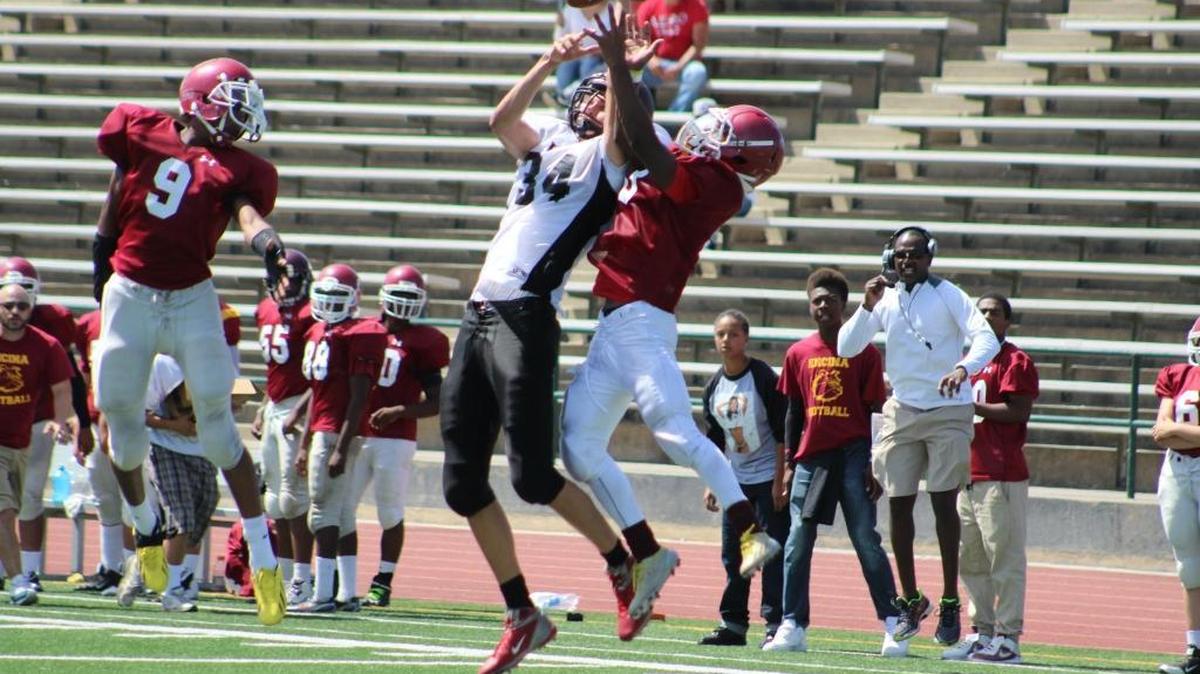 Valley Christian Academy’s Tyler Stoever (34) goes up against Encina in the season opener.