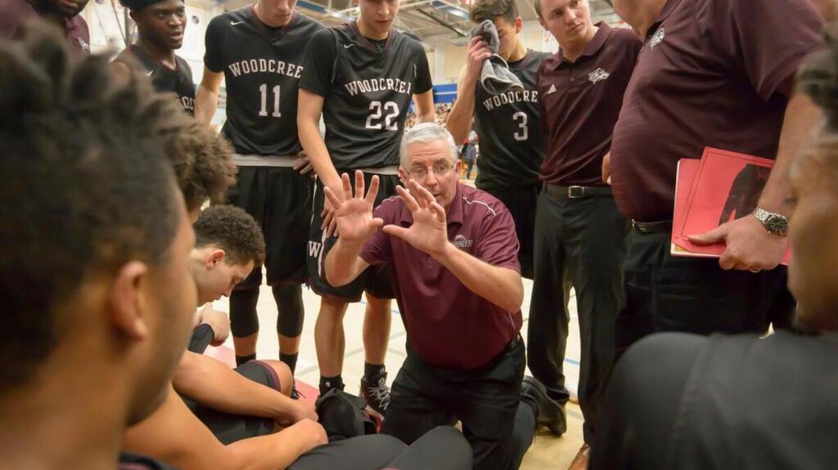 Woodcreek High School Timberwolves basketball head coach Paul Hayes, talks to his players as they play at Folsom High School on Friday.