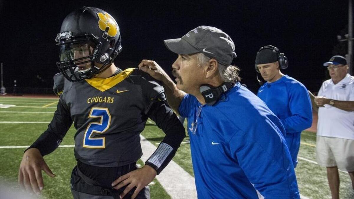 Del Campo coach Mike Dimino, a retired CHP officer, gives his son, quarterback Tyler Dimino, instruction in the first quarter against Oakmont on Oct. 26.